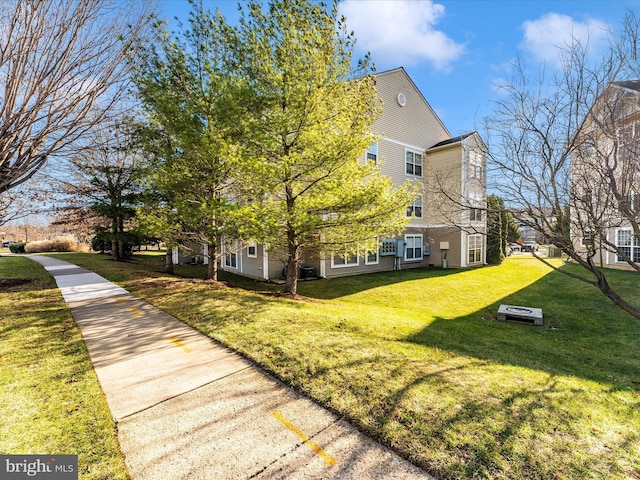 view of side of property featuring a yard