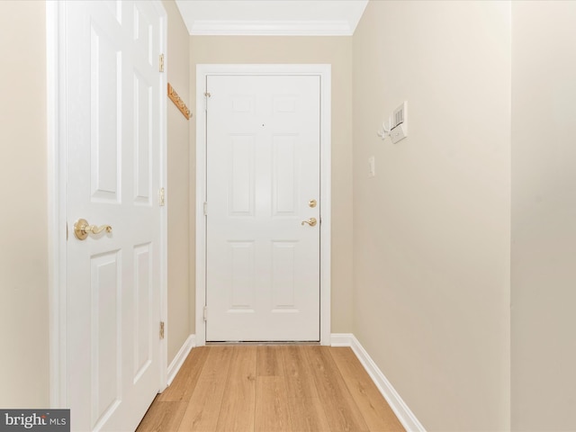 doorway to outside with light wood-type flooring and crown molding