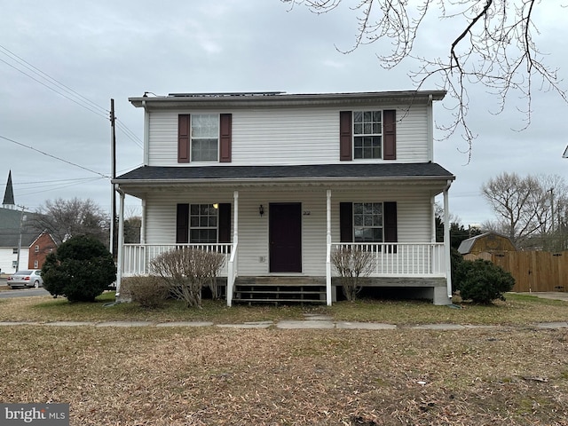 front of property featuring a porch and a front yard