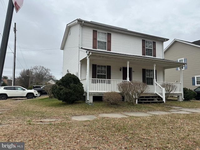 view of front of home with a porch and a front lawn