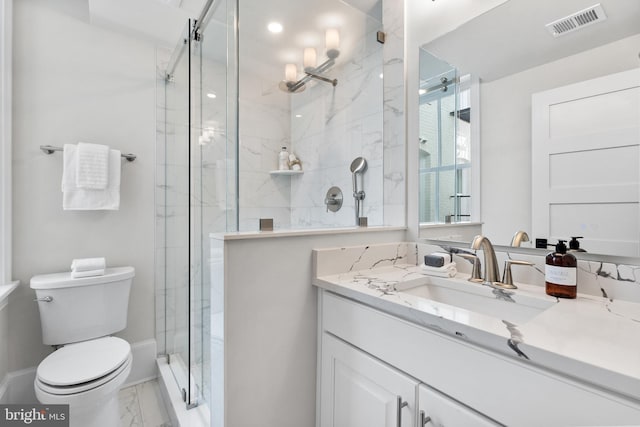 bathroom featuring toilet, vanity, and walk in shower