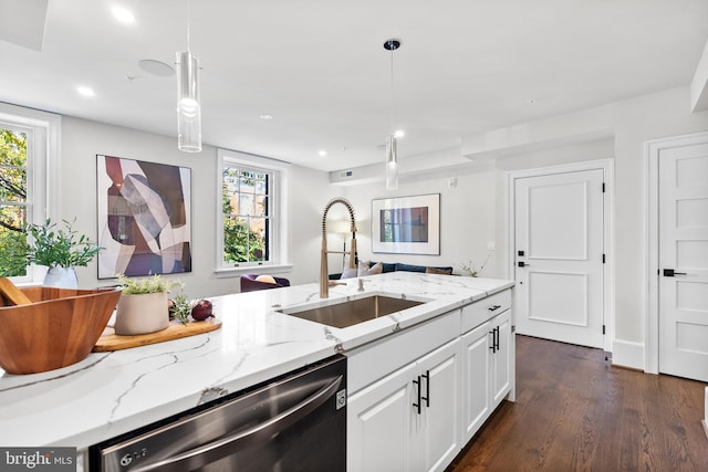 kitchen featuring dishwasher, sink, white cabinets, and decorative light fixtures