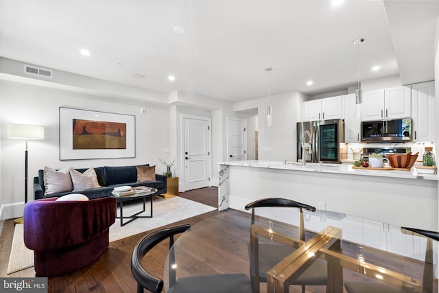 dining space with dark wood-type flooring