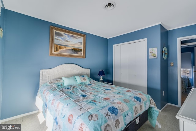 carpeted bedroom with ornamental molding and a closet