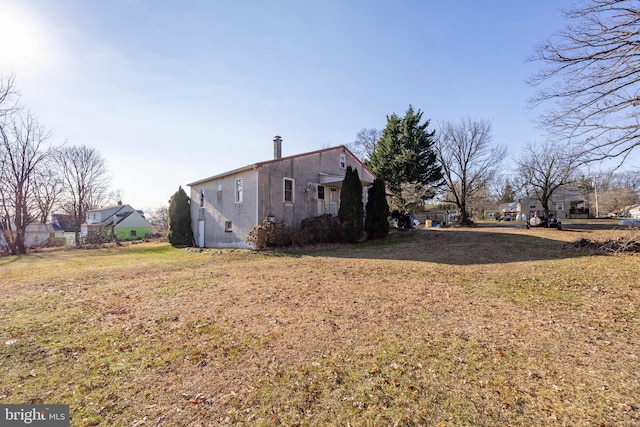 view of side of home featuring a lawn