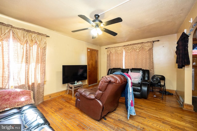 living room featuring ceiling fan and wood-type flooring