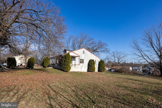 view of property exterior with a yard