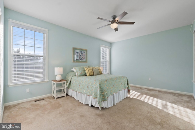 bedroom featuring ceiling fan and light colored carpet