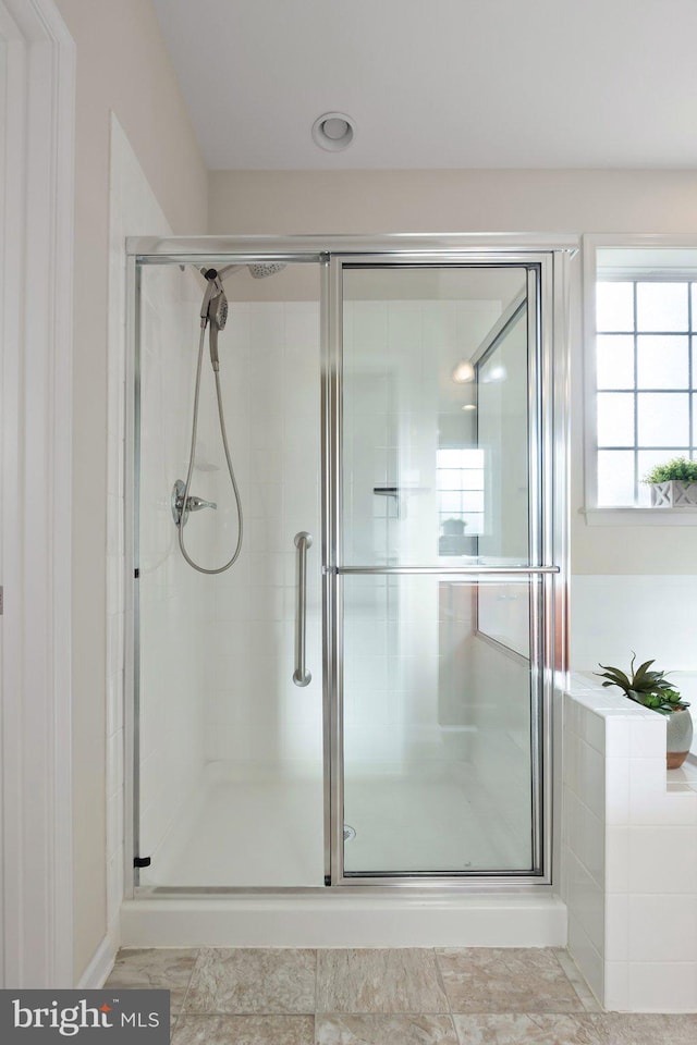 bathroom with a shower with shower door