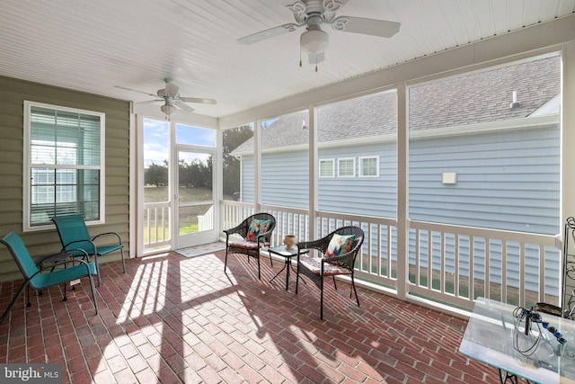 sunroom / solarium featuring ceiling fan