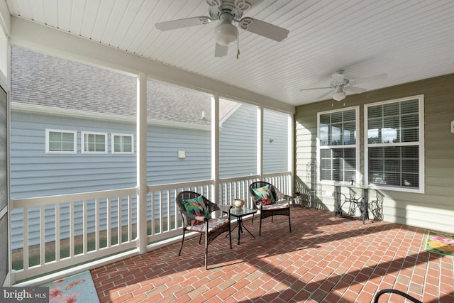 sunroom featuring ceiling fan