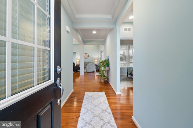 foyer entrance featuring hardwood / wood-style floors and ornamental molding