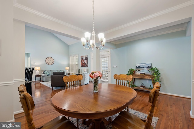 dining area featuring ornamental molding, wood-type flooring, lofted ceiling, and a notable chandelier