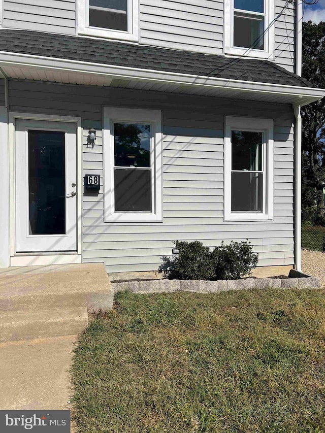 entrance to property with a yard