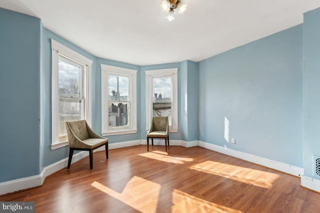 living area with hardwood / wood-style floors