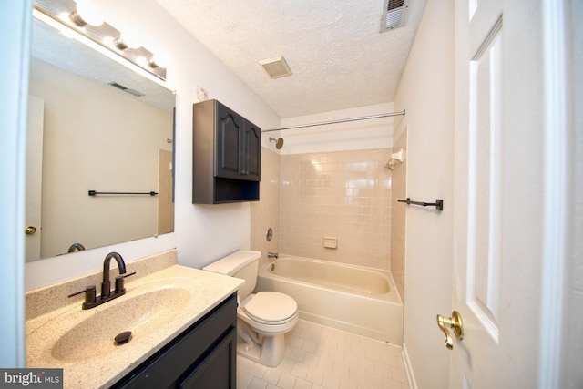 full bathroom with vanity, tiled shower / bath, tile patterned flooring, toilet, and a textured ceiling