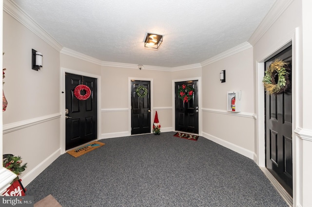 carpeted foyer with crown molding and a textured ceiling