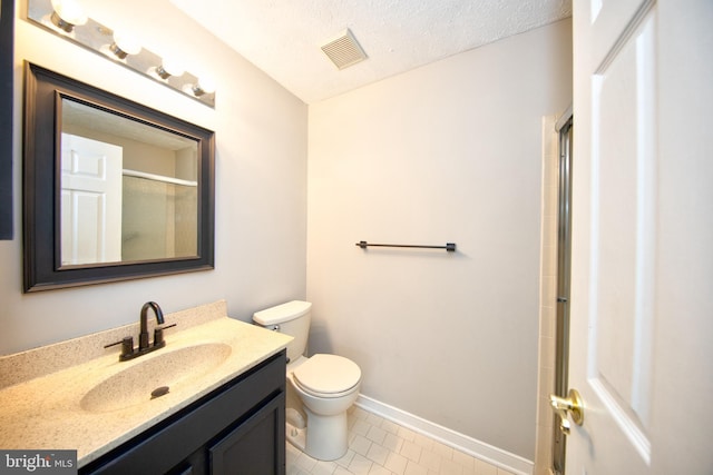 bathroom featuring walk in shower, a textured ceiling, vanity, tile patterned flooring, and toilet