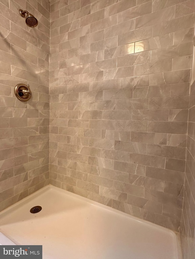 bathroom with tiled shower