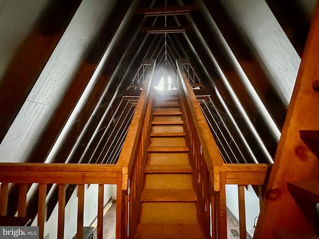 staircase featuring vaulted ceiling