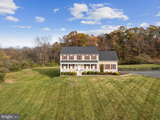 colonial house with covered porch and a front lawn