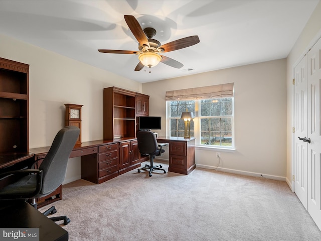 home office with light carpet and ceiling fan