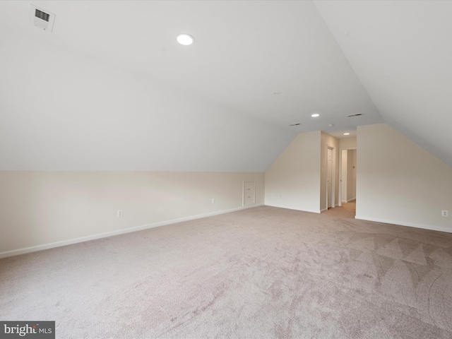 bonus room featuring light colored carpet and vaulted ceiling