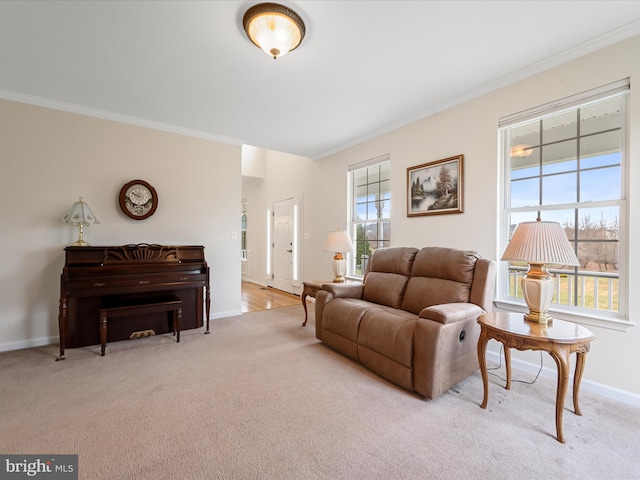 living room with ornamental molding, light colored carpet, and a healthy amount of sunlight