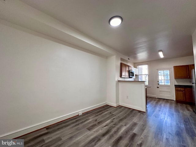 kitchen featuring dark hardwood / wood-style flooring and kitchen peninsula