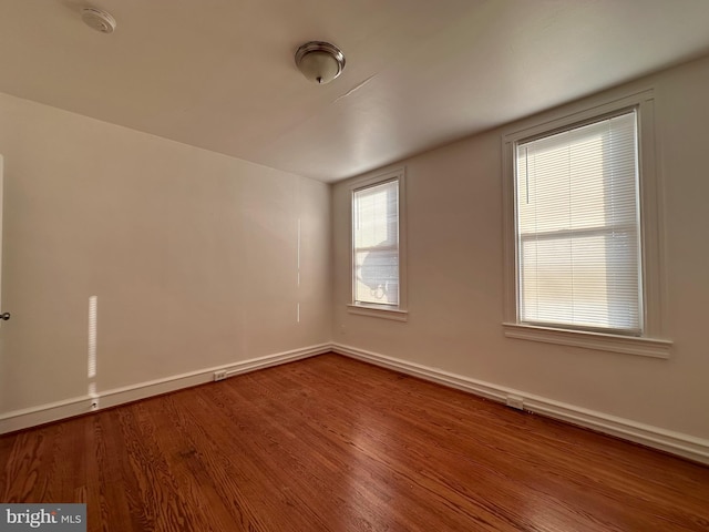 unfurnished room with wood-type flooring