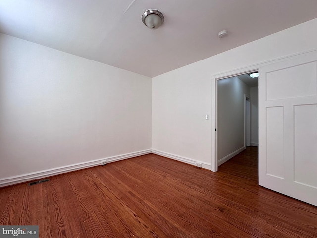 spare room featuring dark hardwood / wood-style flooring