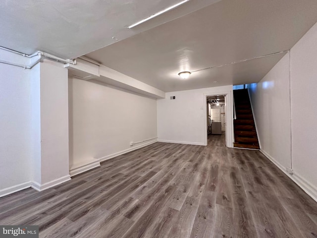 basement featuring dark hardwood / wood-style flooring