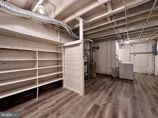 basement featuring wooden ceiling, fridge, dark wood-type flooring, and water heater