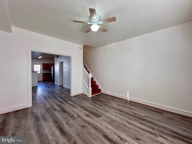 unfurnished living room with ceiling fan and dark hardwood / wood-style flooring