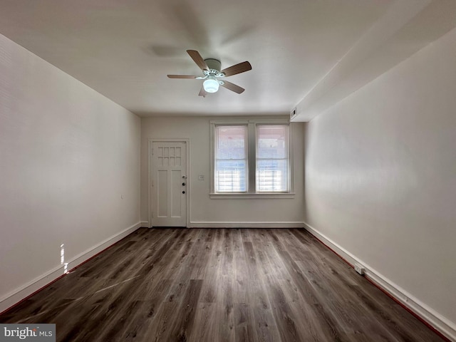 spare room featuring dark hardwood / wood-style floors and ceiling fan