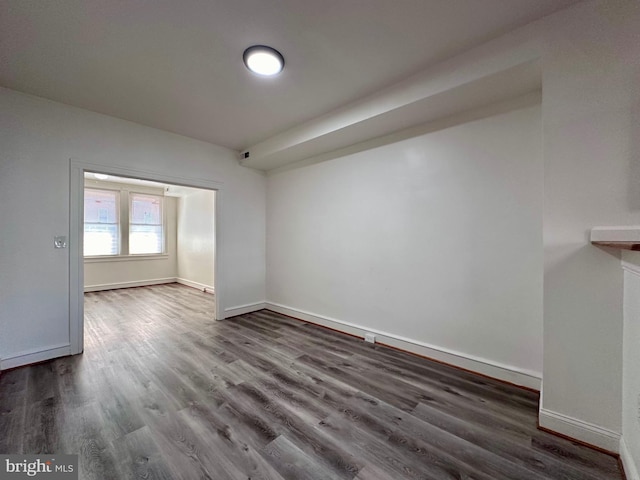 spare room with dark hardwood / wood-style floors