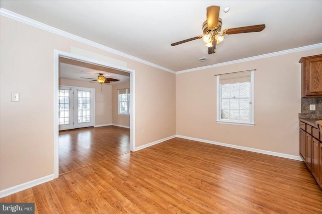 unfurnished living room with ceiling fan, french doors, crown molding, and light hardwood / wood-style flooring