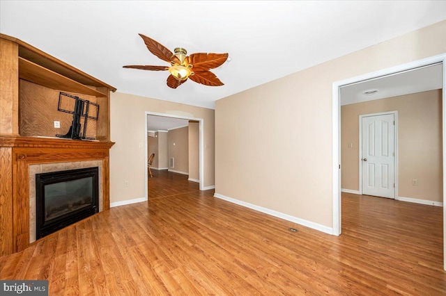 unfurnished living room featuring hardwood / wood-style floors and ceiling fan