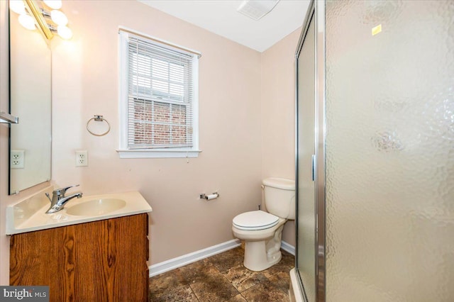 bathroom featuring vanity, an enclosed shower, and toilet