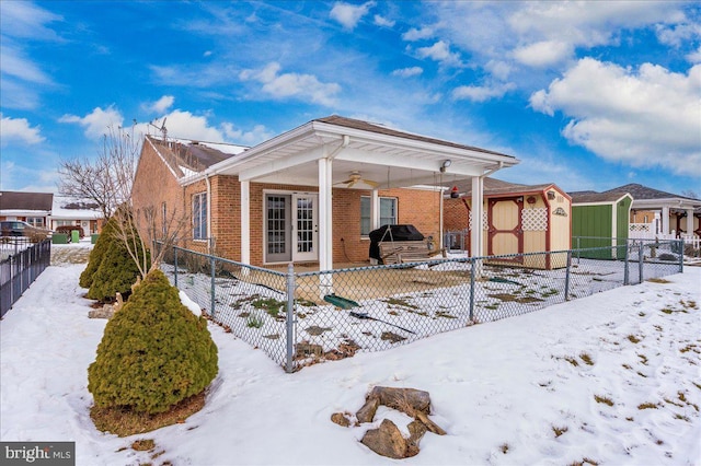 exterior space with ceiling fan and a storage shed