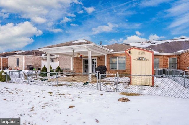 view of snow covered rear of property