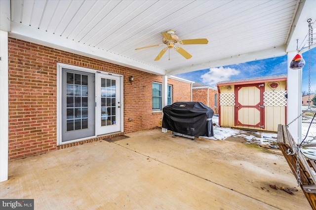 view of patio / terrace with grilling area, a storage shed, and ceiling fan