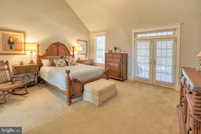 bedroom with access to exterior, light colored carpet, multiple windows, and lofted ceiling