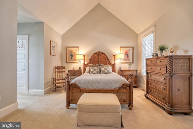 carpeted bedroom featuring lofted ceiling