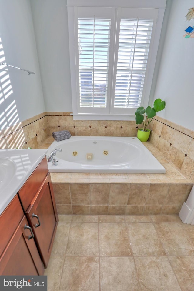 bathroom with tiled bath and vanity