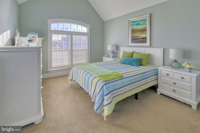 bedroom with light carpet and vaulted ceiling