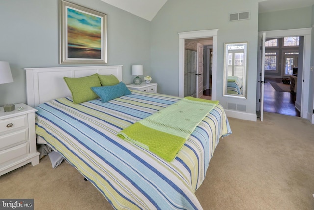 bedroom with light carpet and lofted ceiling