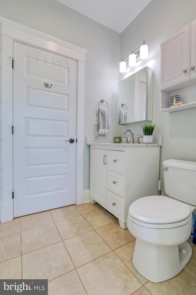 bathroom with tile patterned floors, vanity, and toilet