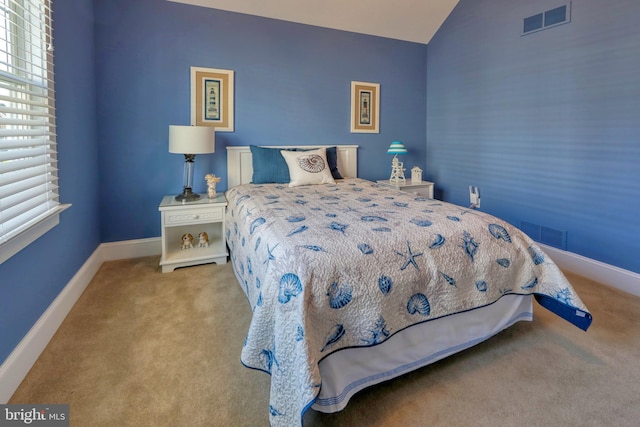 bedroom featuring carpet flooring and lofted ceiling