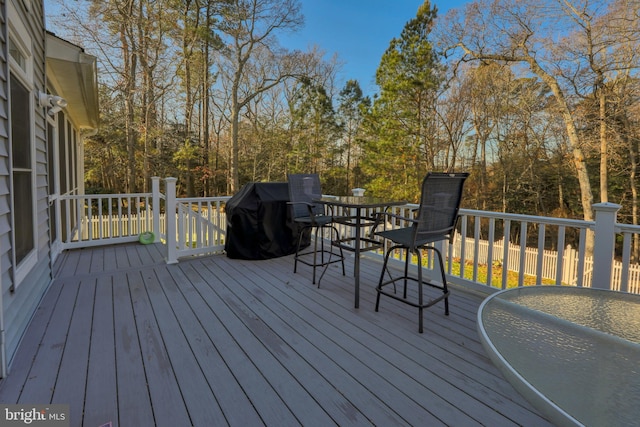 wooden deck with a grill